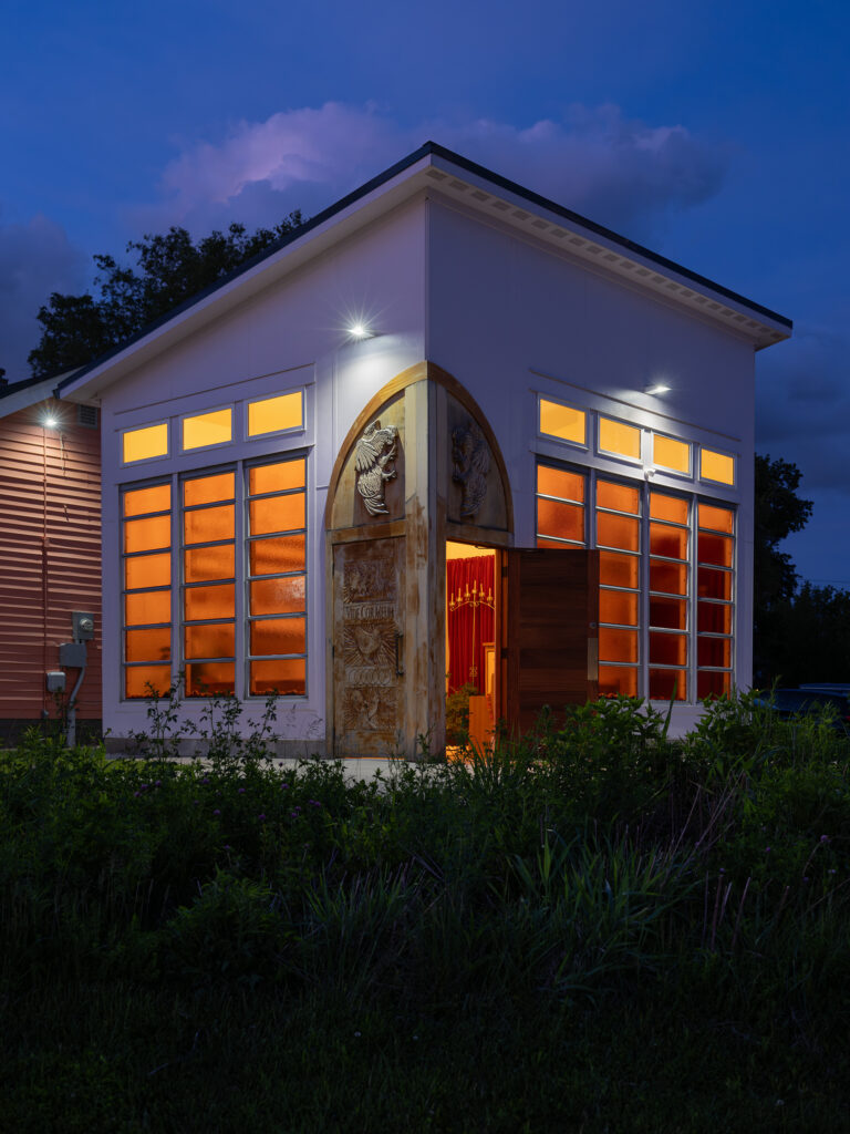 The "Chicken Chapel of Love" glows in the night.